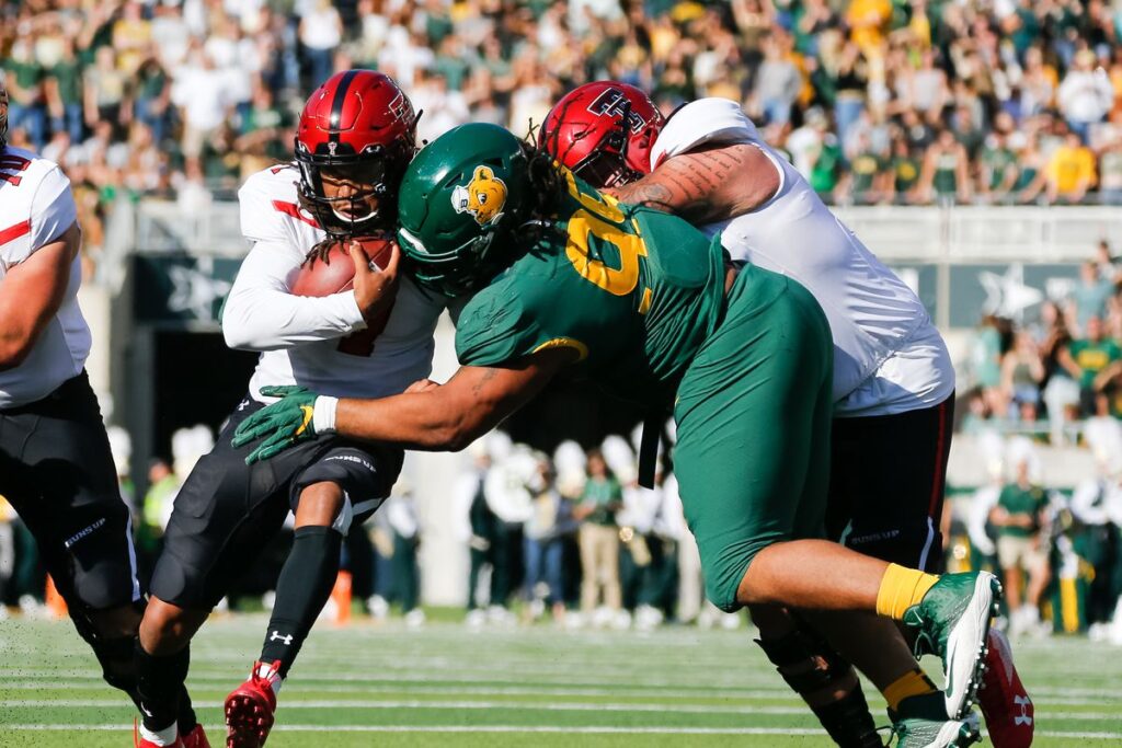 a Baylor player being block to the ground